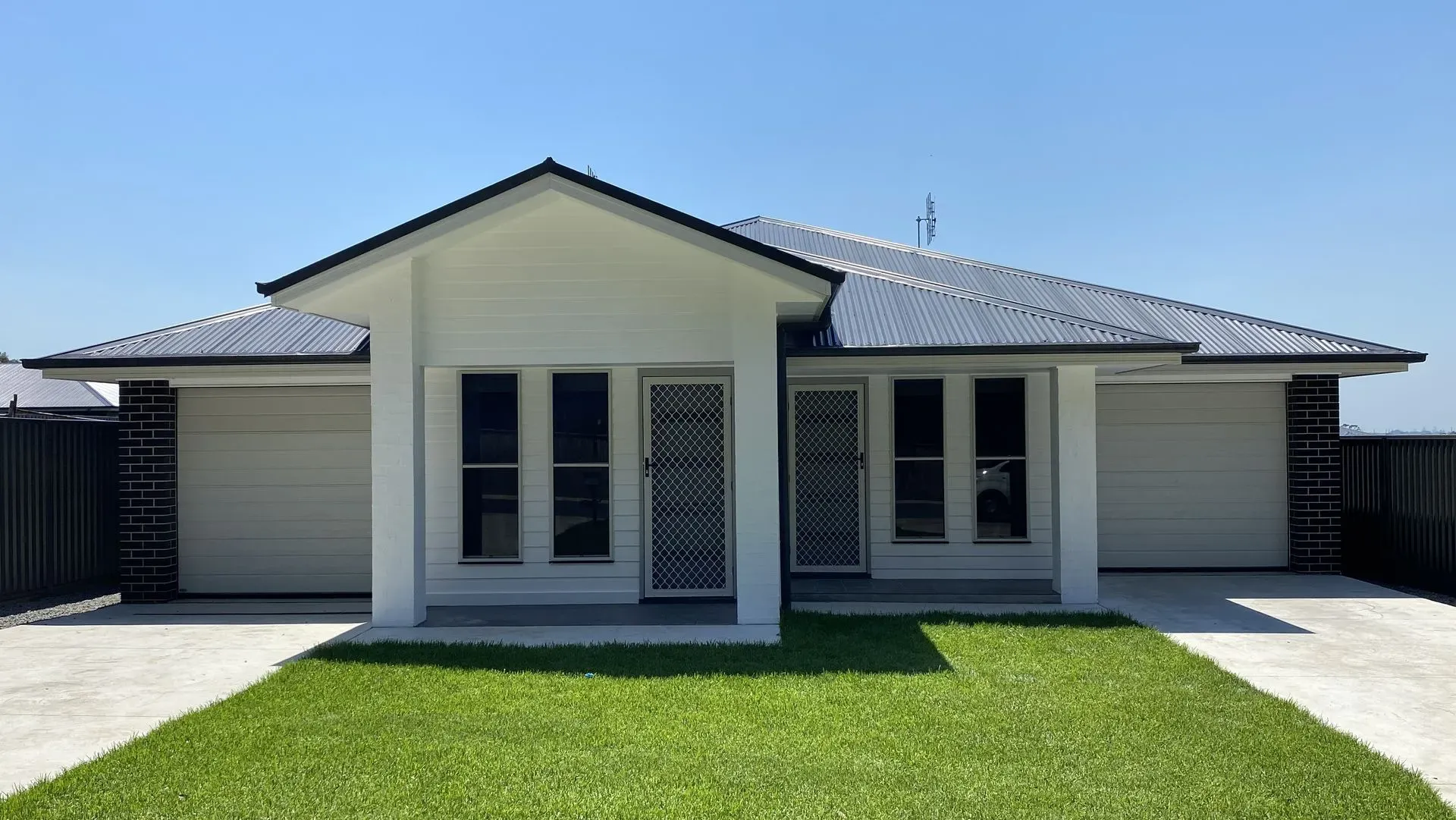 Freshly painted white weatherboard duplex exterior in Sydney