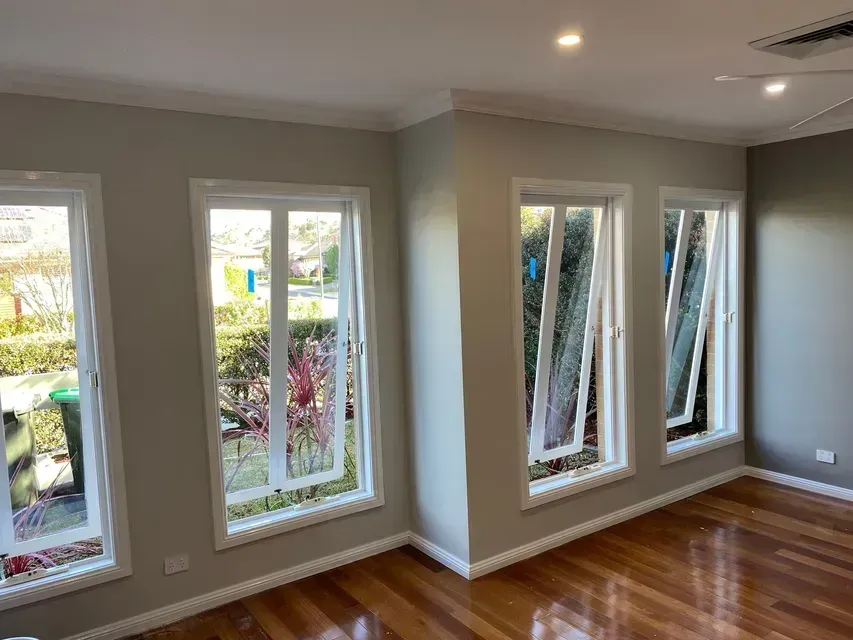Bright repainted room with large windows and white trims