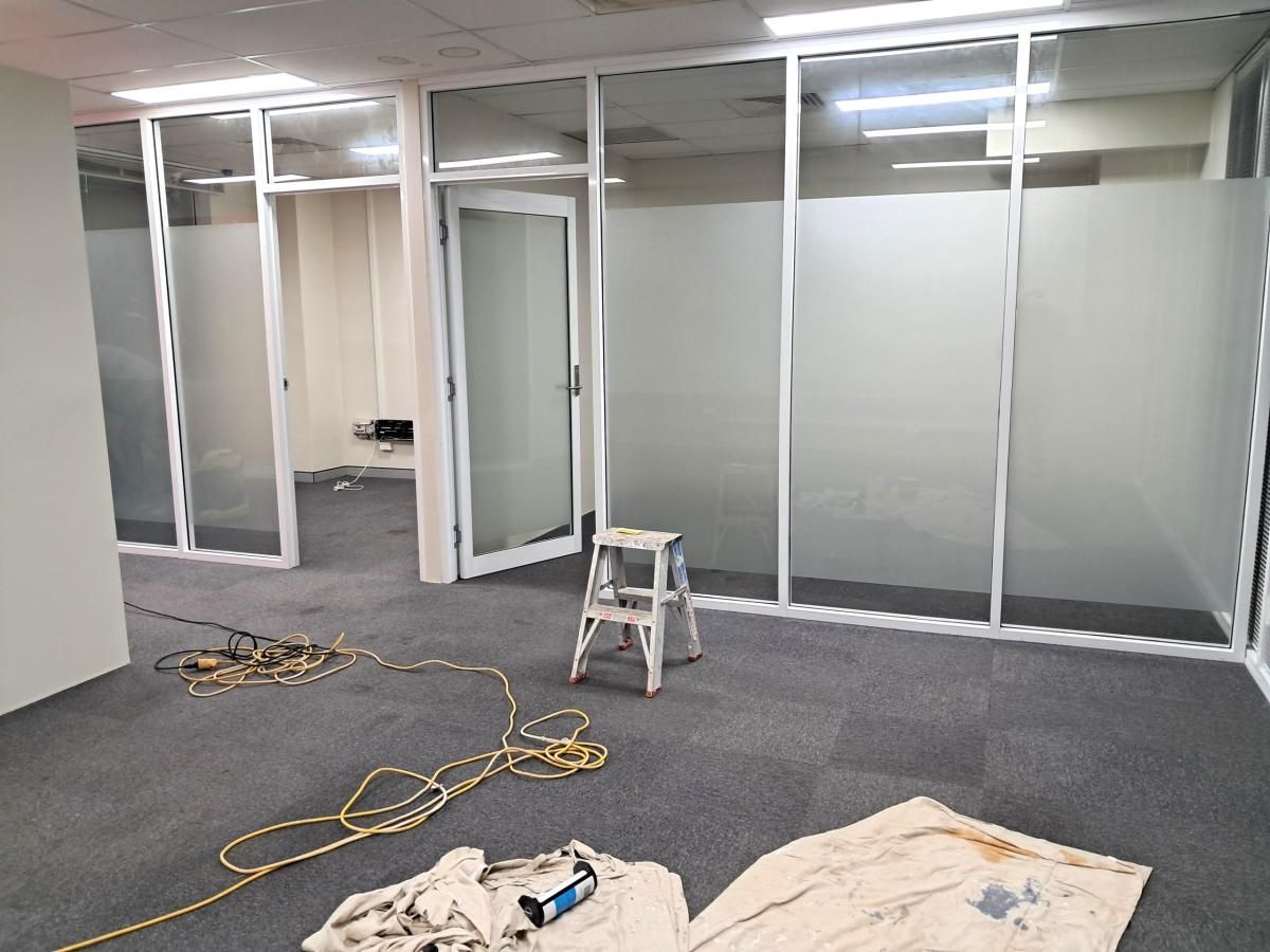 Office partitions repainted after hours with floors protected