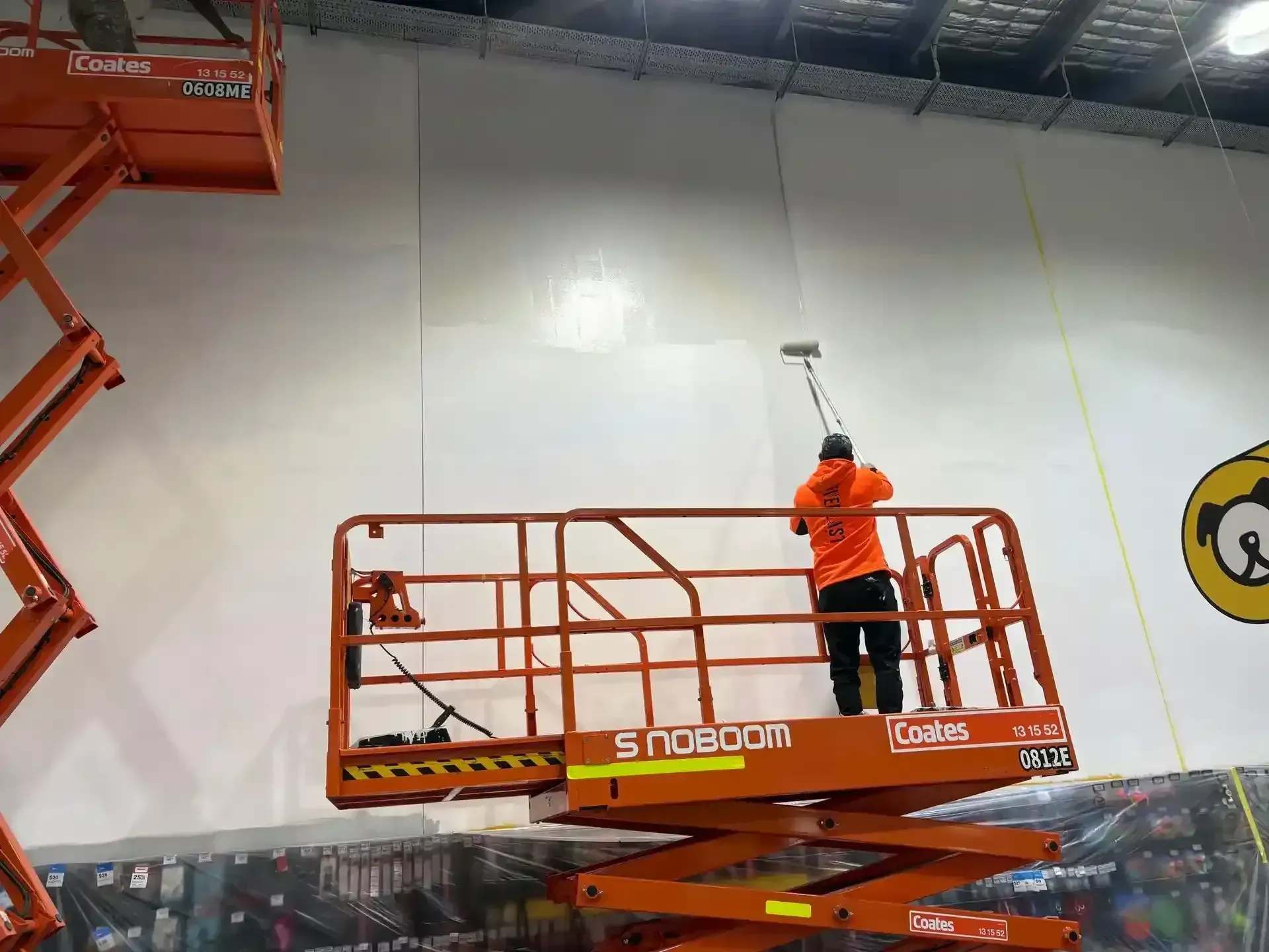 Painter working from a scissor lift during an after-hours job