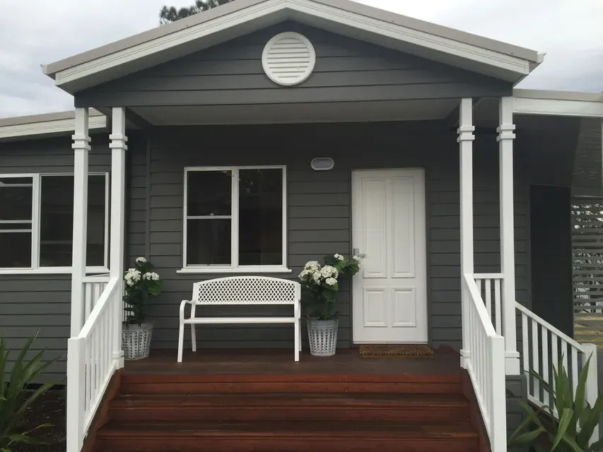 Weatherboard home exterior painted charcoal with white trims