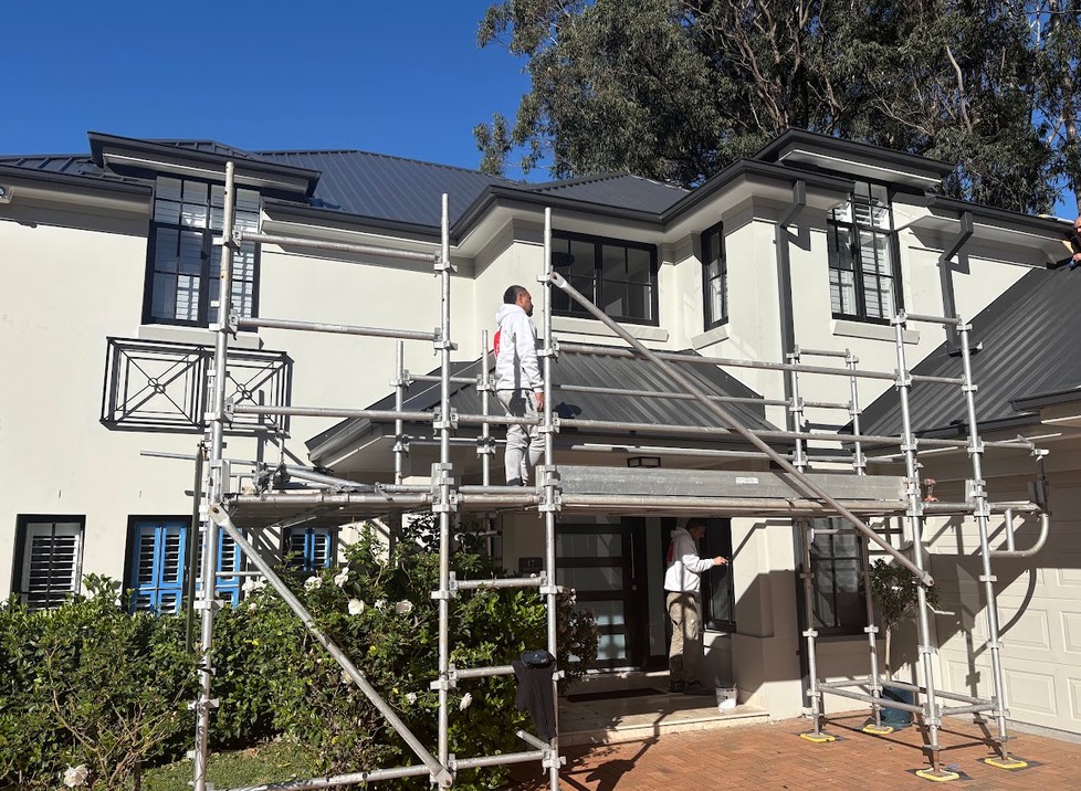 Norwest Painting Group painters on scaffold repainting a two-storey West Pennant Hills home